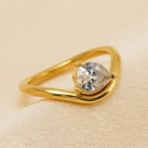 Close-up detail of a pear-cut zircon set on an 18k gold plated stainless steel V-shaped ring.
