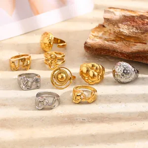 Detailed view of minimalist stainless steel rings with hammered texture and geometric patterns