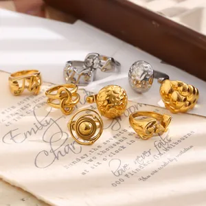 Close-up of stylish gold and silver titanium steel rings with hammered texture details