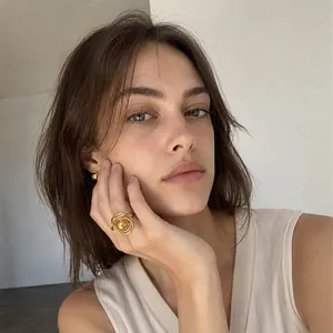 Minimalist 18K gold plated stainless steel ring with sphere detail worn by model