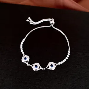 Vue détaillée d'un bracelet coulissant œil protecteur argenté avec zircons bleus étincelants