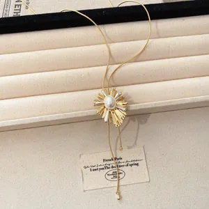 Detail of vintage 18k gold plated sunburst necklace with pearl and adjustable slider