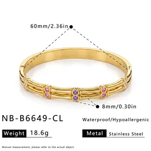 Detail view of gold stainless steel bamboo bangle with purple and pink zircon stones.