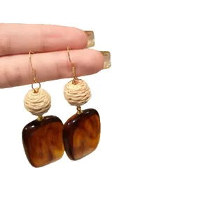 Vintage retro style acrylic square drop earrings featuring hand-woven straw ball design