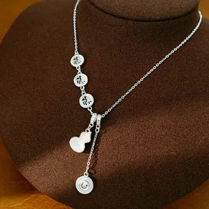 Silver gourd necklace with mother of pearl inlay and Fu character charms on brown display.