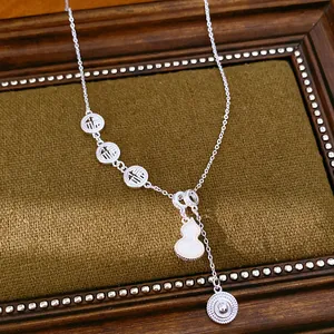 Detailed view of silver necklace with hollow Fu characters and shell gourd pendant
