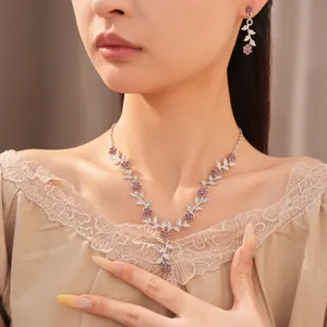 Detailed view of elegant palace style floral leaf necklace and earrings jewelry set.