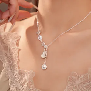 Close-up of 18k gold plated necklace with hollow Fu character and shell gourd pendant