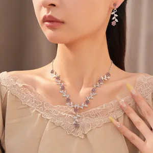 Detailed view of vintage leaf and flower jewelry set with pink stones on a model