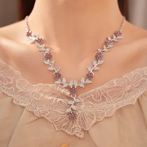 Detail of palace style necklace with purple floral and leaf rhinestone inlay
