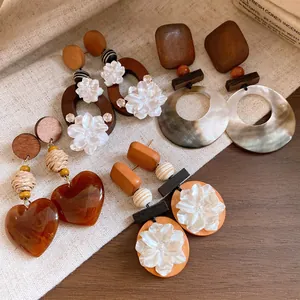 Detaillierte Ansicht von Vintage-Ohrringen aus Holz und Muscheln in verschiedenen Designs