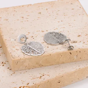 Detailed close-up of vintage hollow monstera leaf design stainless steel earrings
