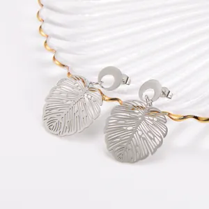 Macro view of minimalist stainless steel hollow-out Monstera leaf design stud earrings