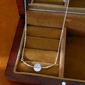 Minimalist curved bar necklace with sparkling round zircon displayed in a luxury wooden box