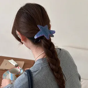 Detailed view of a denim texture star-shaped hair clip on a braided ponytail hairstyle