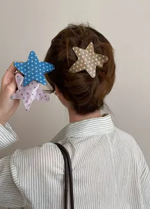 Set of acetate star hair clips with star and polka dot patterns shown on model