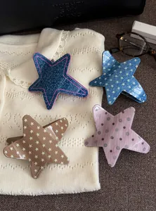 Collection of four star-shaped acetic acid hair clips featuring denim and polka dot patterns
