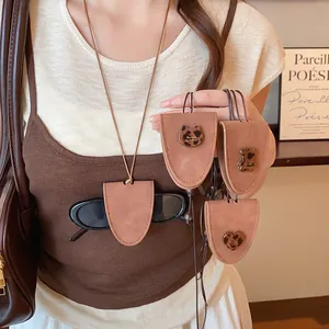 Detail showing brown faux leather glasses clip necklaces with leopard charms