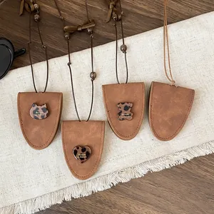 Detailed view of four brown triangular glasses holder necklaces with leopard print charms.
