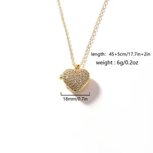 Close-up detail of a gold heart locket necklace with sparkling cubic zirconia pavé stones