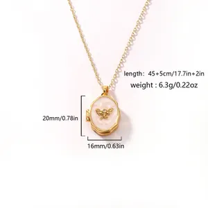 Detailed macro view of gold butterfly locket necklace with dimension and weight specifications
