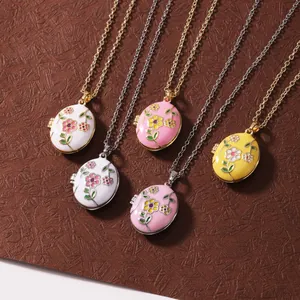 Detailed view of five colorful floral enamel locket necklaces with gold and silver chains
