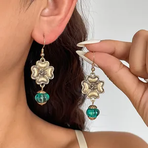 Vintage gold flower dangle earrings with translucent green resin beads