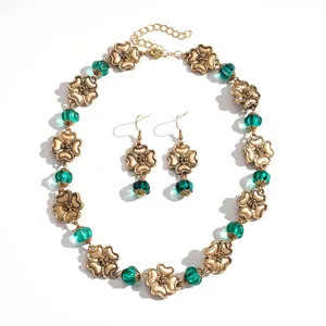 Vintage gold metal flower necklace with teal resin beads and matching floral earrings