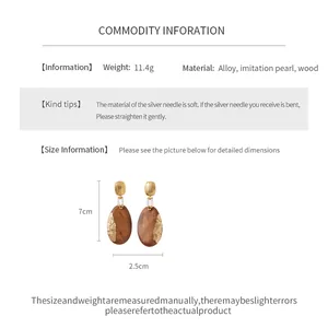 Detailed view of specification and dimensions for oval wood earrings with gold foil accents