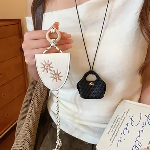 Close-up detail of handmade sunflower glasses clip and black woven mini bag necklace set