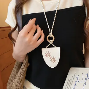White leather glasses clip necklace with sun embroidery and woven long cord