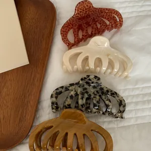 Set of four large acrylic leopard print and marble finish hair claw clips for elegant buns