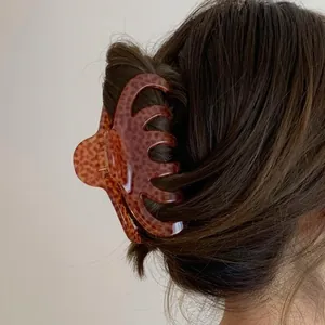 Large acrylic leopard print hair claw clip for elegant bun styling and thick hair