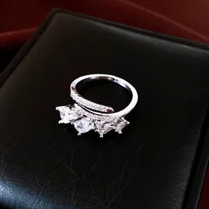 Macro view of an elegant silver open ring featuring four pear-cut cubic zirconia stones
