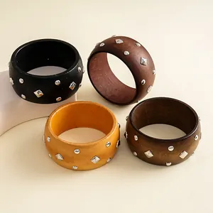 Retro ethnic style wooden bangles featuring geometric silver rivets in four assorted colors.