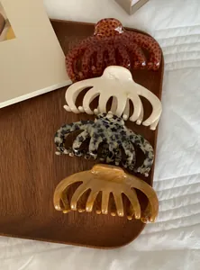 Set of four large acrylic hair claws featuring elegant marble and leopard patterns