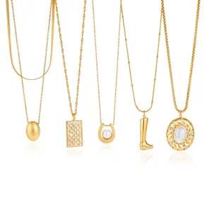 Detailed view of five unique gold-plated stainless steel necklaces with various pendants.