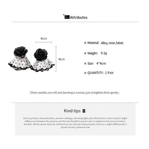 Detailed specifications for black flower stud earrings featuring polka dot fabric skirt