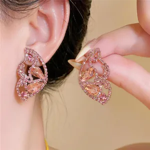 Detailaufnahme eleganter rosa Strass-Ohrstecker in Schmetterlingsflügelform auf Silber