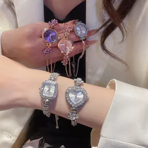 Exquisite detail view of luxury rhinestone watches in heart and floral bracelet styles.