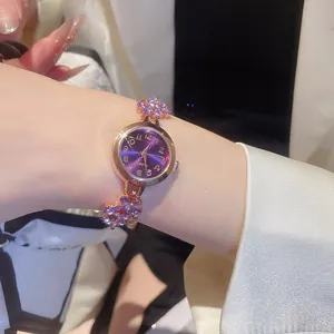 Detailed view of an elegant purple rhinestone flower bracelet watch for women