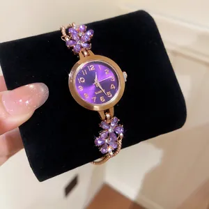 Elegant purple flower bracelet watch with gold case and crystal petal detailing