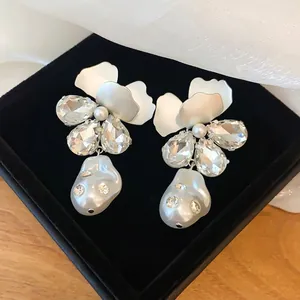 Elegante bloemenoorbellen in Franse stijl met fonkelende kristallen en witte barokparels
