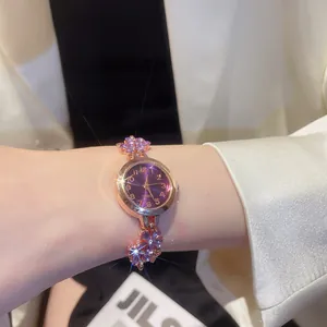 Close-up of elegant floral crystal bracelet watch for women with a vibrant purple dial