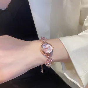 Close-up of elegant rose gold bracelet watch with sparkling floral diamond accents