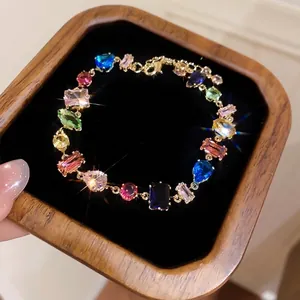 Vibrant multi-color gemstone bracelet with geometric crystals in a luxury wooden tray
