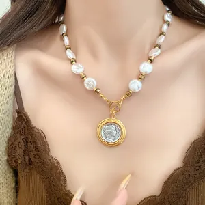 Detail of French vintage pearl necklace featuring a classical silver portrait coin pendant.