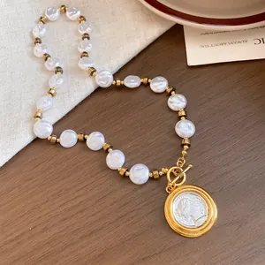 Detailed view of French vintage necklace with white beads and a circular portrait pendant