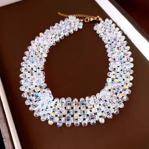 Iridescent faceted beaded choker necklace with gold clasp on brown gift box display.