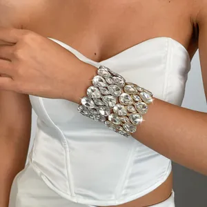 Detailed view of a luxury teardrop rhinestone elastic bracelet on a female model.